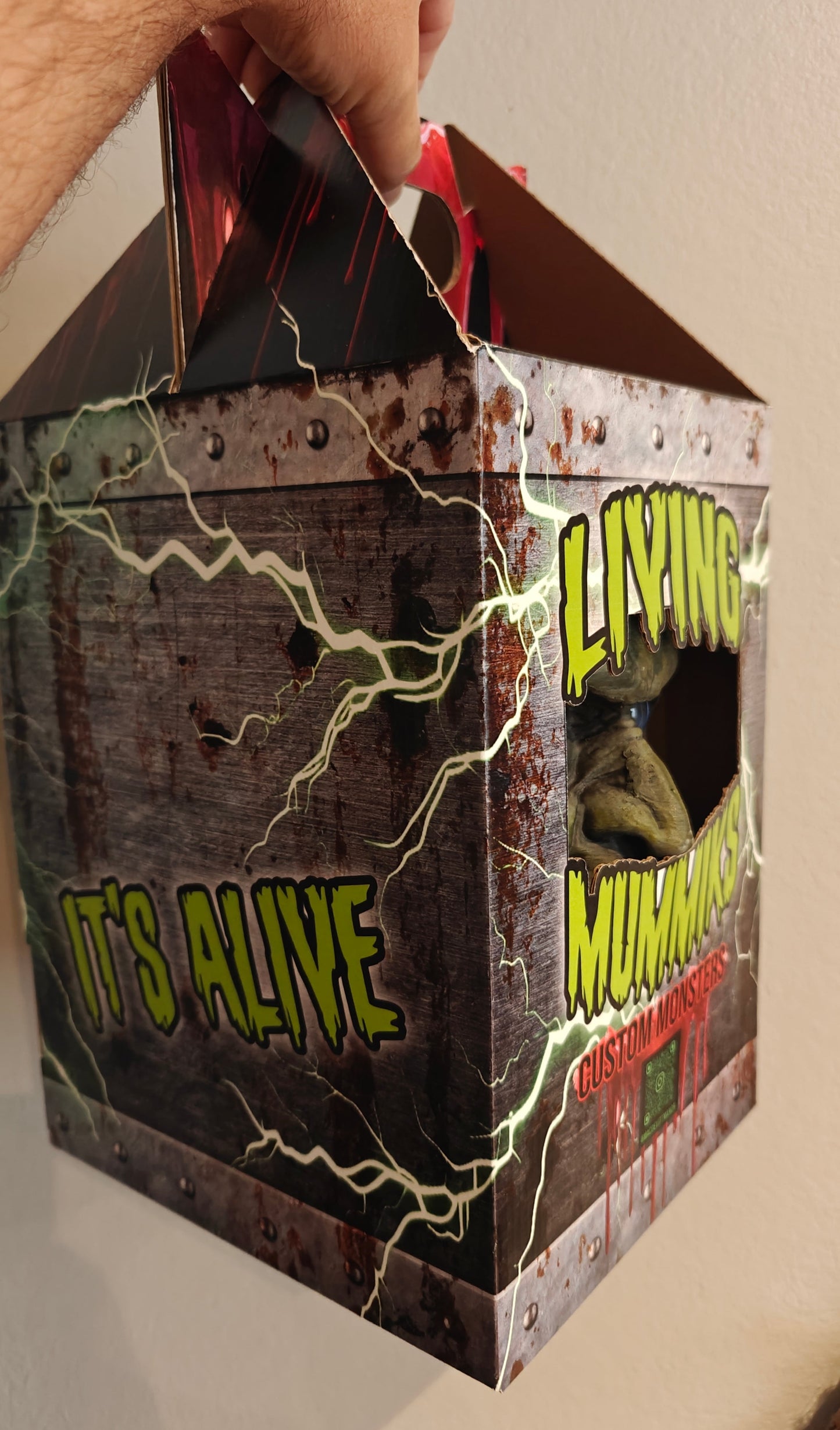 Living Mummys Halloween box with 'It's Alive' text and zombie graphic on a plain background. Frankenstein Monster 3D printed Bust with Living Mummiks Display Box and Digital eyes kit installed. Halloween, Horror Display.