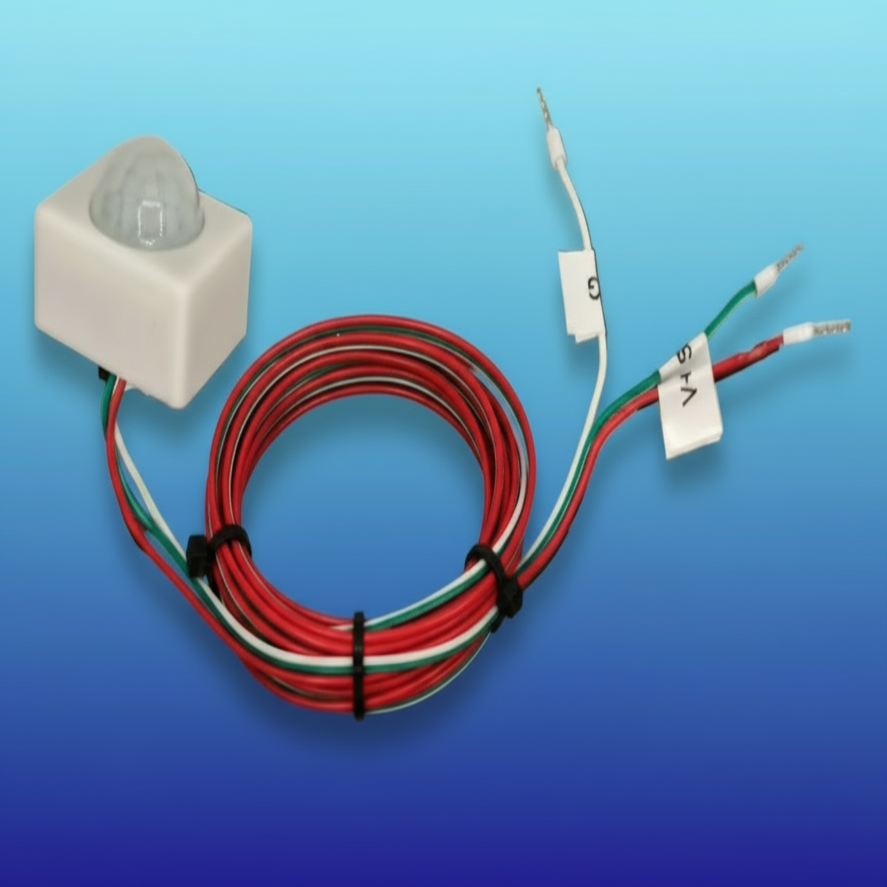 Electrical components including a sensor, wiring, and connectors on a blue background