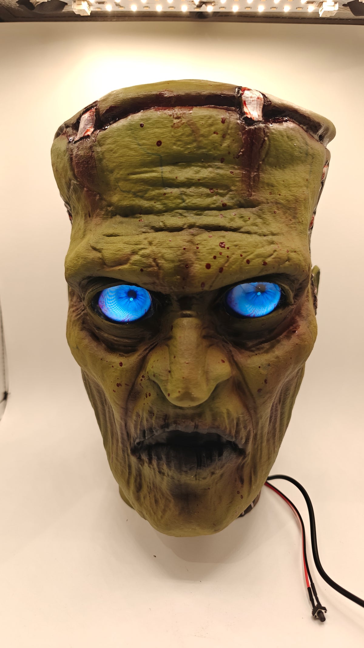 Updated Frankenstein Bust 1, front view with installed blue digital eyes and detailed airbrushed scars.