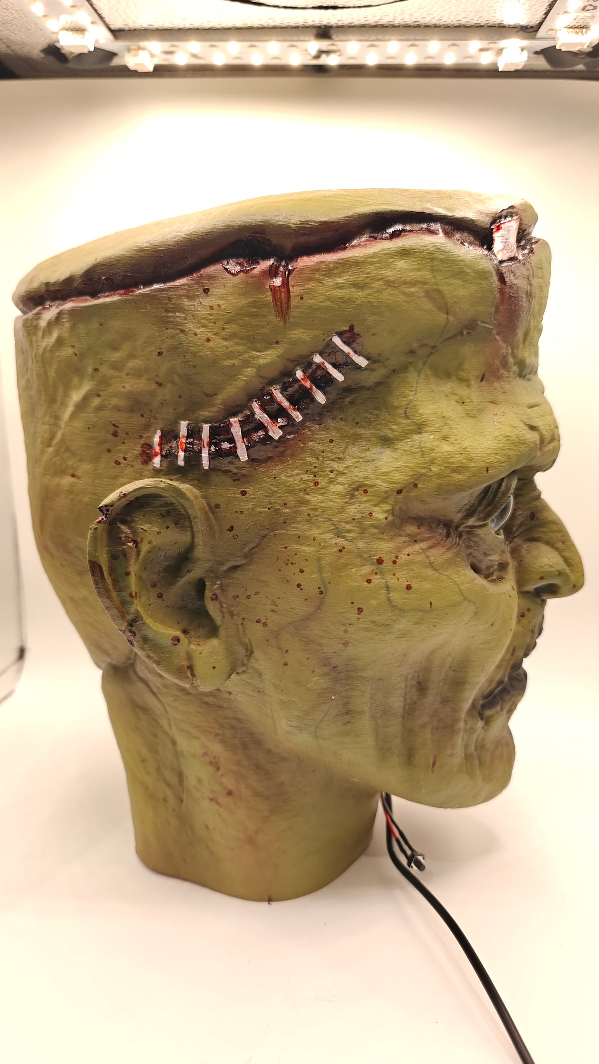 Frankenstein Bust 1, side profile with sculpted forehead stitches and neck base.