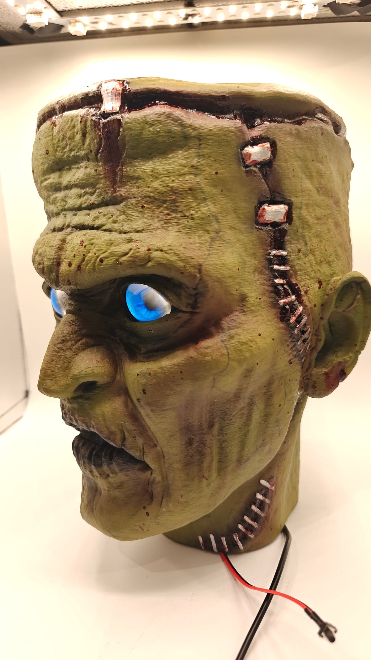 Frankenstein Bust 1, three-quarter view with digital eyes and detailed forehead and neck scars.