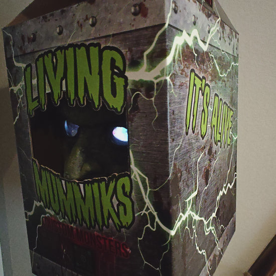 Living Mummiks custom monsters packaging with a hand holding the box.
Frankenstein  Monster 3D printed  Bust with Living Mummiks Display Box  and Digital eyes kit installed. Halloween, Horror Display.